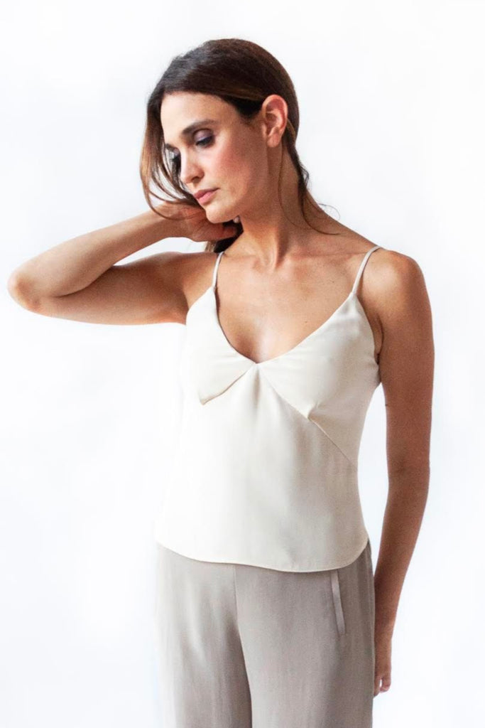 Model in 4 ply silk crepe thin strap camisole in white and 4 ply silk crepe high waist pants in color fungi