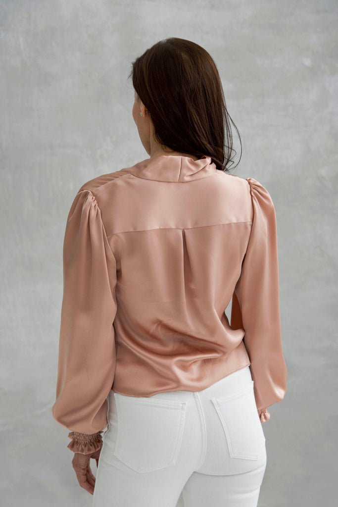 Rachel Ackley in silk charmeuse blouse long sleeves in color blush back view
