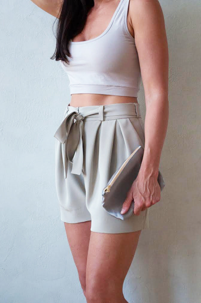Rachel Ackley in grey organic cotton crop tank and 4 ply silk crepe paper bag tie shorts in color ivory side view