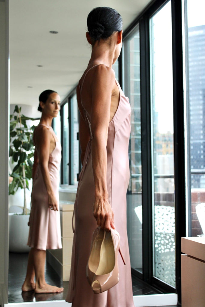 Amanda Lachowicz dress in silk charmeuse in color blush side standing in front of mirror